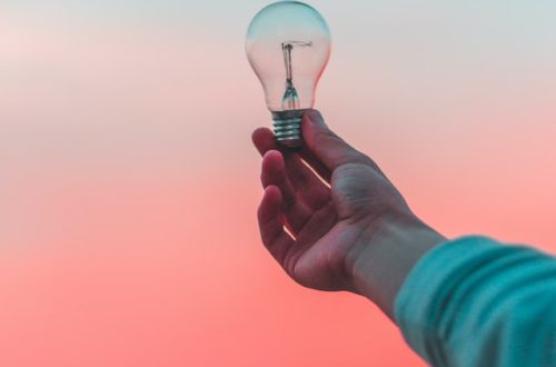 an outstretched arm with a lightbulb