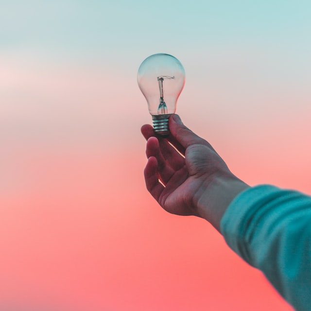 an outstretched arm with a lightbulb